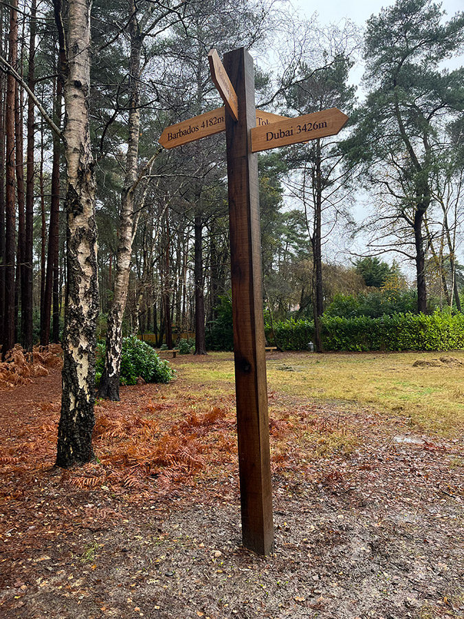 wood road distance sign